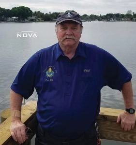a man standing next to a body of water