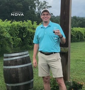 a man standing in front of a barrel