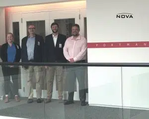 a person standing in front of a group of people posing for the camera