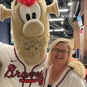 a person standing in front of a stuffed toy posing for the camera