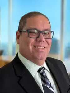 a man wearing glasses and a suit and tie